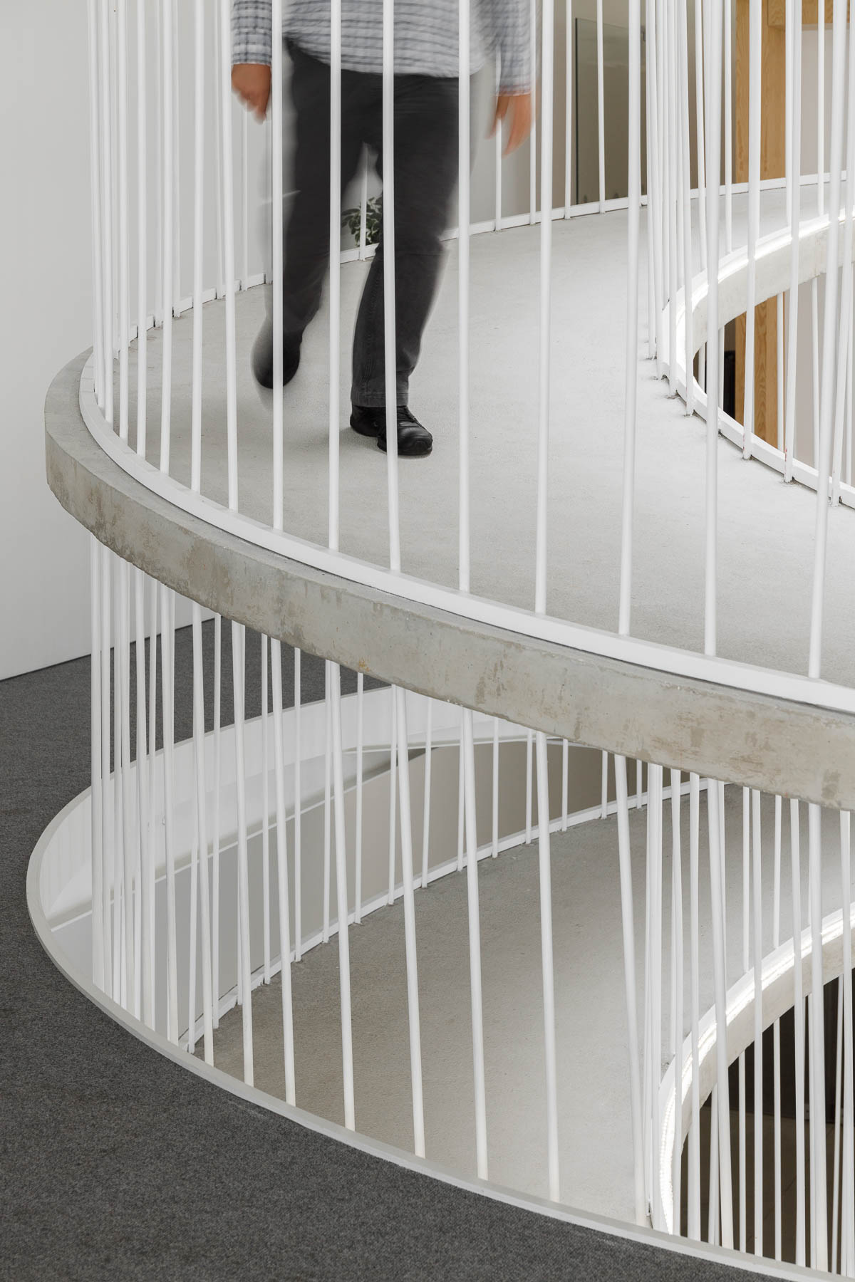 A spiraling ramp replaces the need for stairs in this modern office and adds a sculptural element.