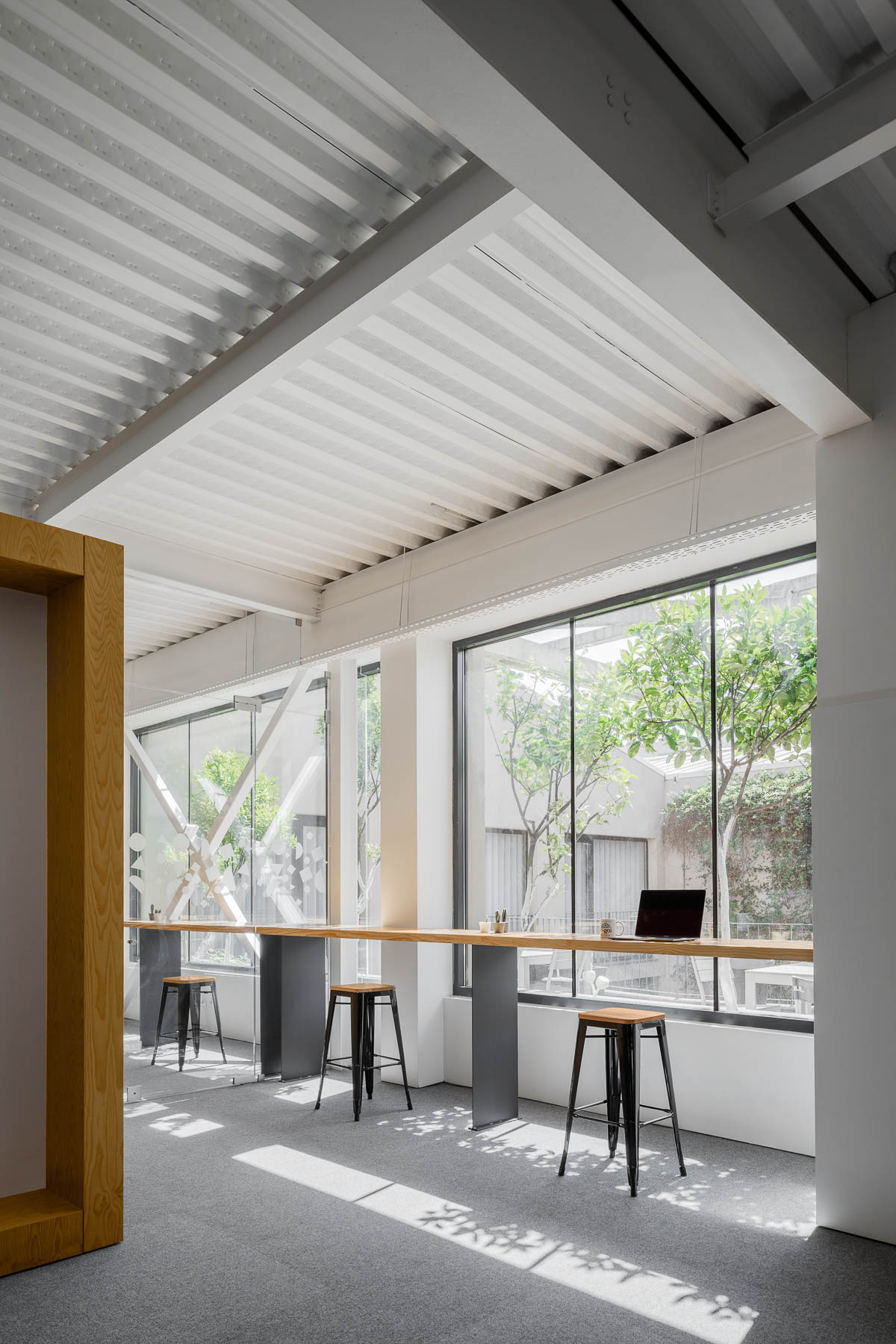 A modern office with seating by the windows that take advantage of the natural light.