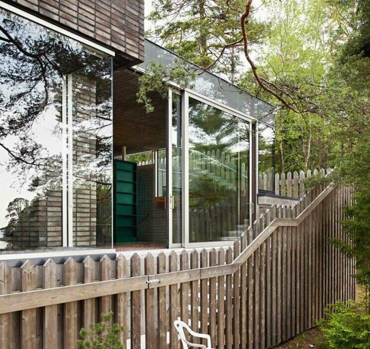 wooden hedge facade enfolds villa on the coastline of stockholm