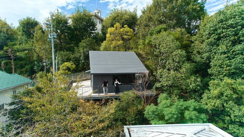 wooden house in yagota by airhouse floats in the japanese forest 