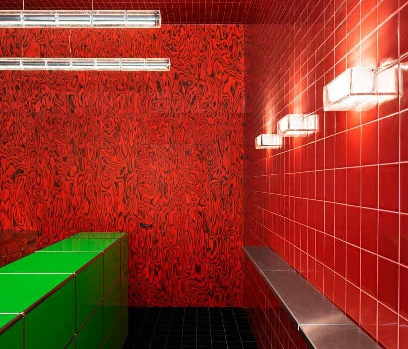 glossy red tiles dynamically contrast with lime green counter within spazio maiocchi’s new bar