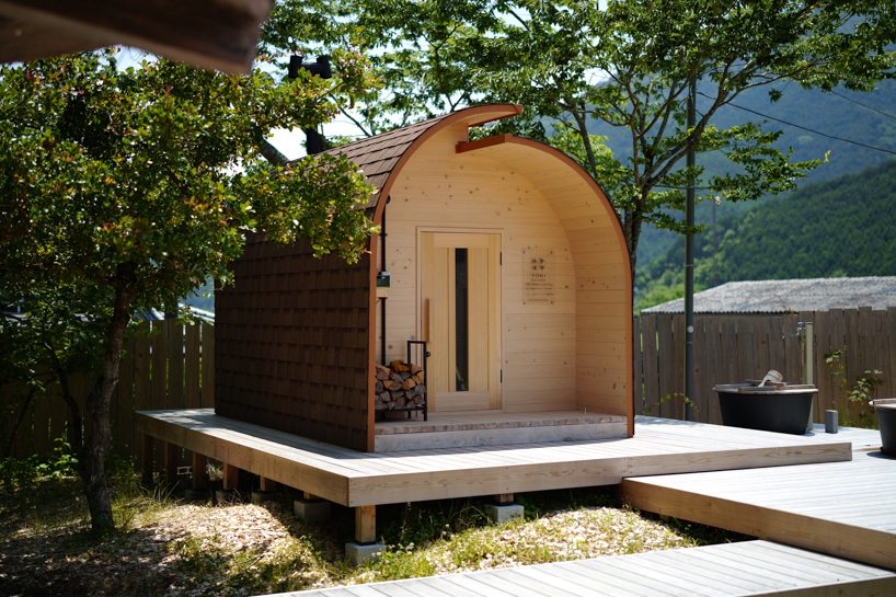 thinned trees from japanese forest compose barrel-shaped sauna with stepped ceiling