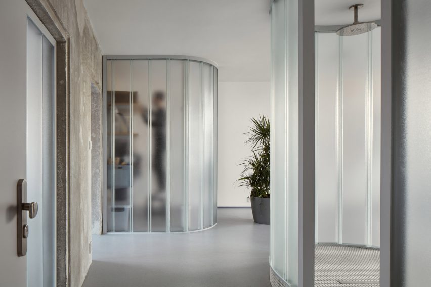 Neuhäusl Hunal divide open-plan apartment using curved glass walls