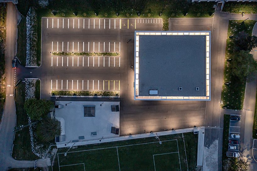 monolithic concrete volume houses sports hall in switzerland