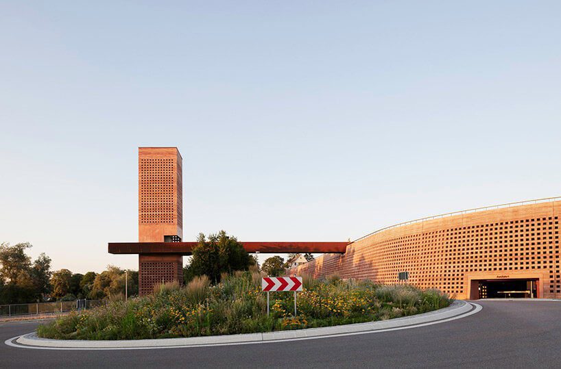 MONO architekten builds a tower of red-tinted rammed earth