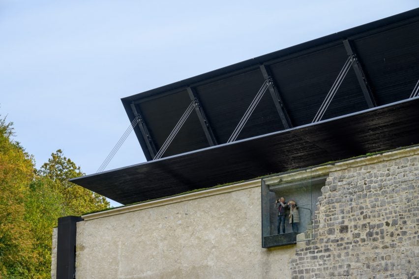 Medprostor encloses 12th-century church with folding roof in Slovenia