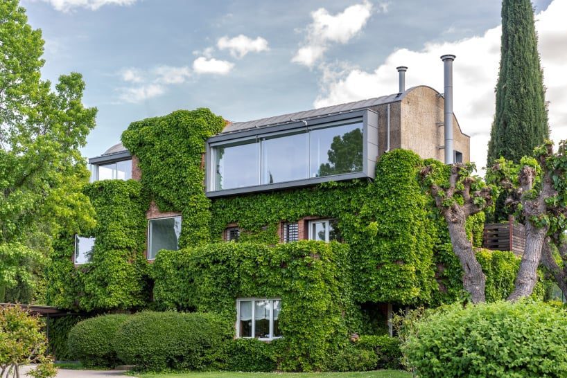 eme 157’s domehome emerges from foliage-covered brick house in spain