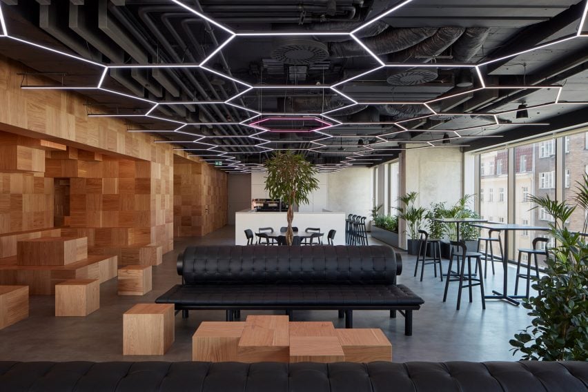 Collcoll hides stairs in pixellated wooden structure at Pricefx office