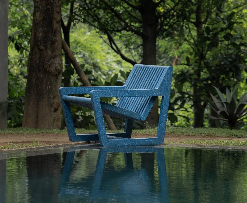 Blue Ombak chair next to a pool