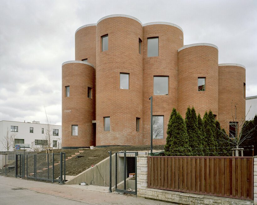 christian kerez's house okamura unfolds as a cluster of circular brick volumes in czechia